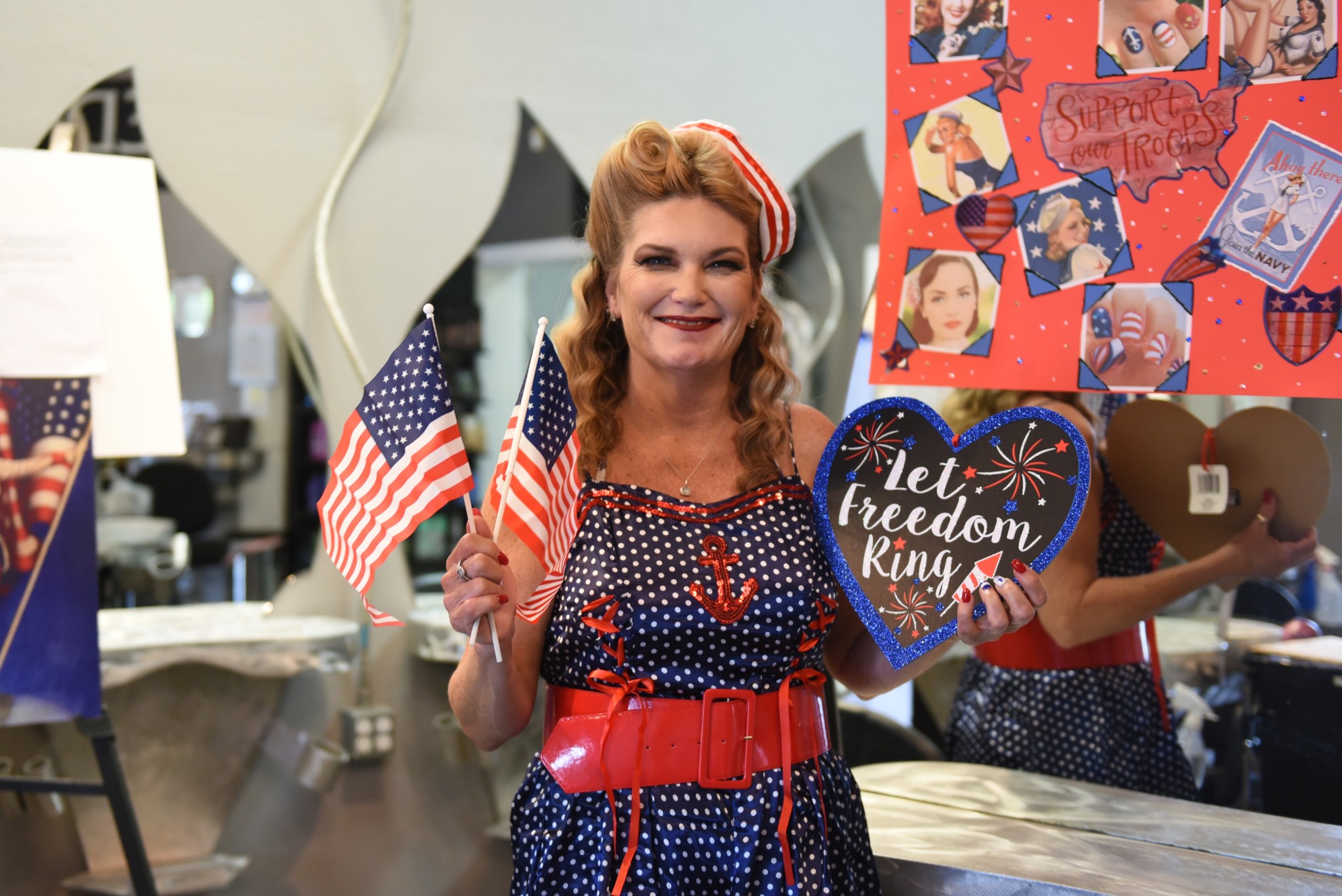 Woman dressed in red white and blue dress with a red and white striped hat celebrating freedom